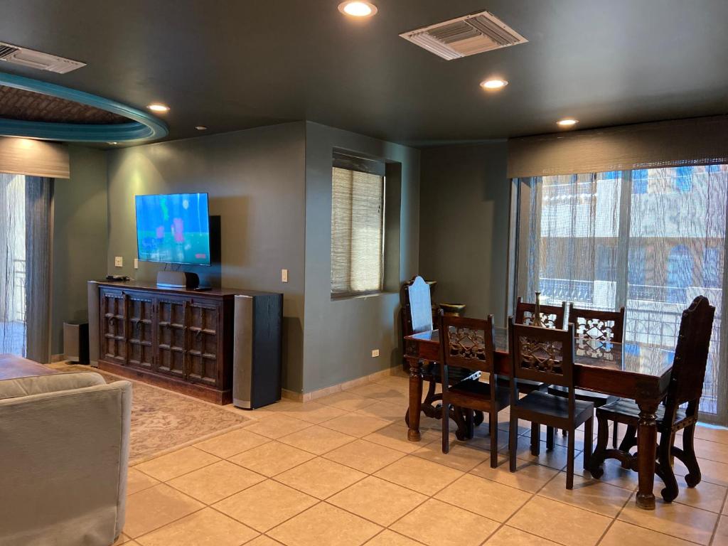 a dining room with a table and chairs and a tv at Bella Sirena in La Choya