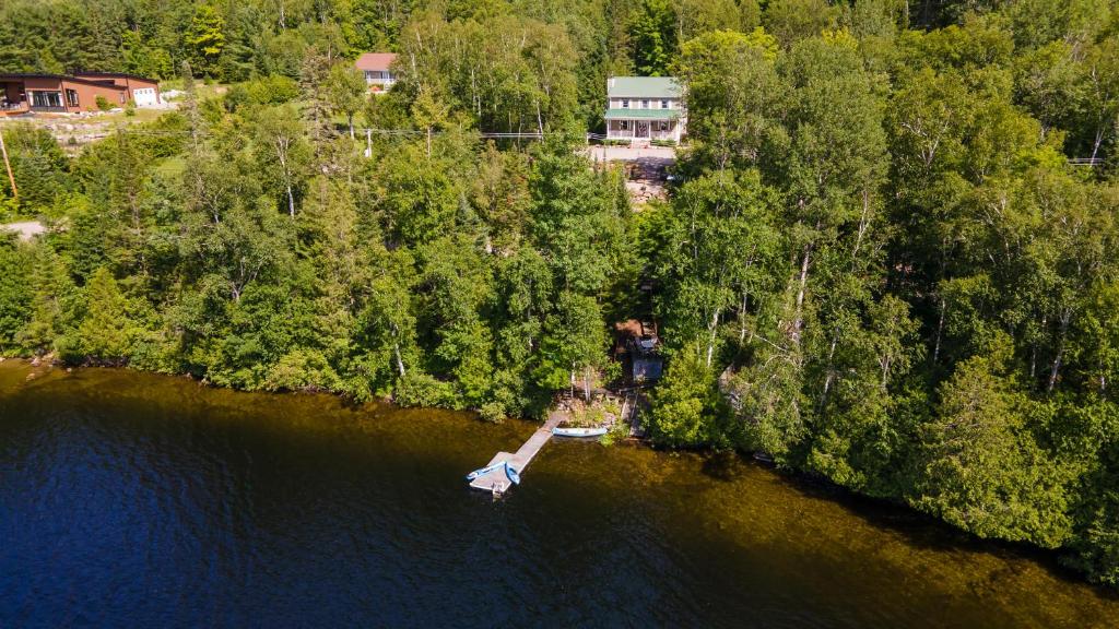 an aerial view of a house on a island in the water at Lake and Pool Table - Au Pied du Lac in Labelle