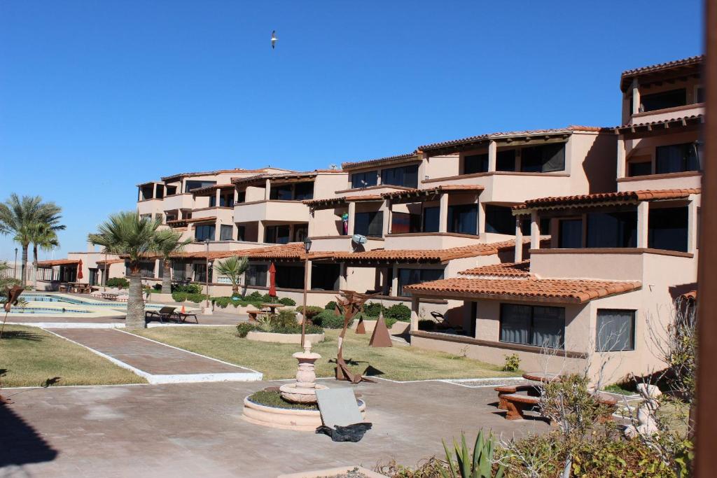 a large apartment building with a courtyard with a fountain at Las Gaviotas 402 Mid-century Ocean View Apartment in Puerto Peñasco