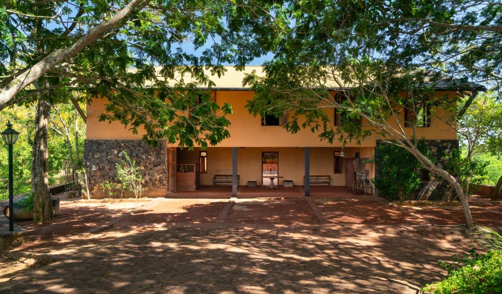 a building with trees in front of it at Cinnamon Museum Mirissa in Mirissa