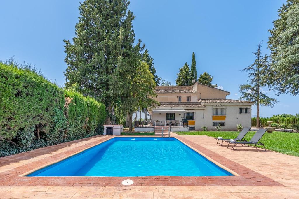 a swimming pool in the backyard of a house at Huerto del Carmen in Santa Fe