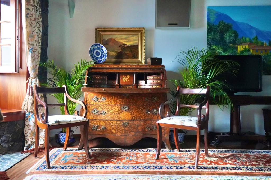 a living room with two chairs and a dresser at Modern Luxury Canarian House in Garachico