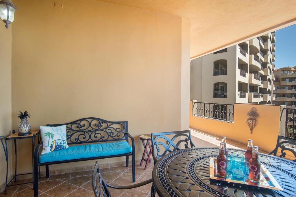 a balcony with a couch and a table and chairs at Bella Sirena in La Choya