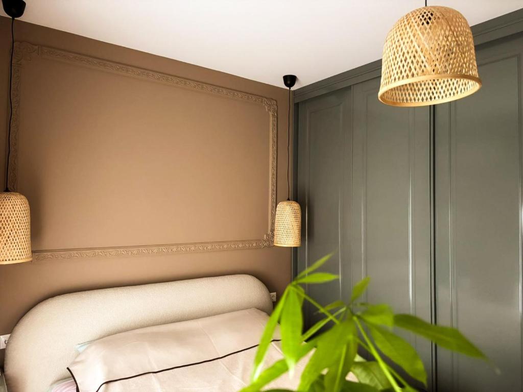 a room with a chair and a potted plant at Maison de Luxe in Chalkida