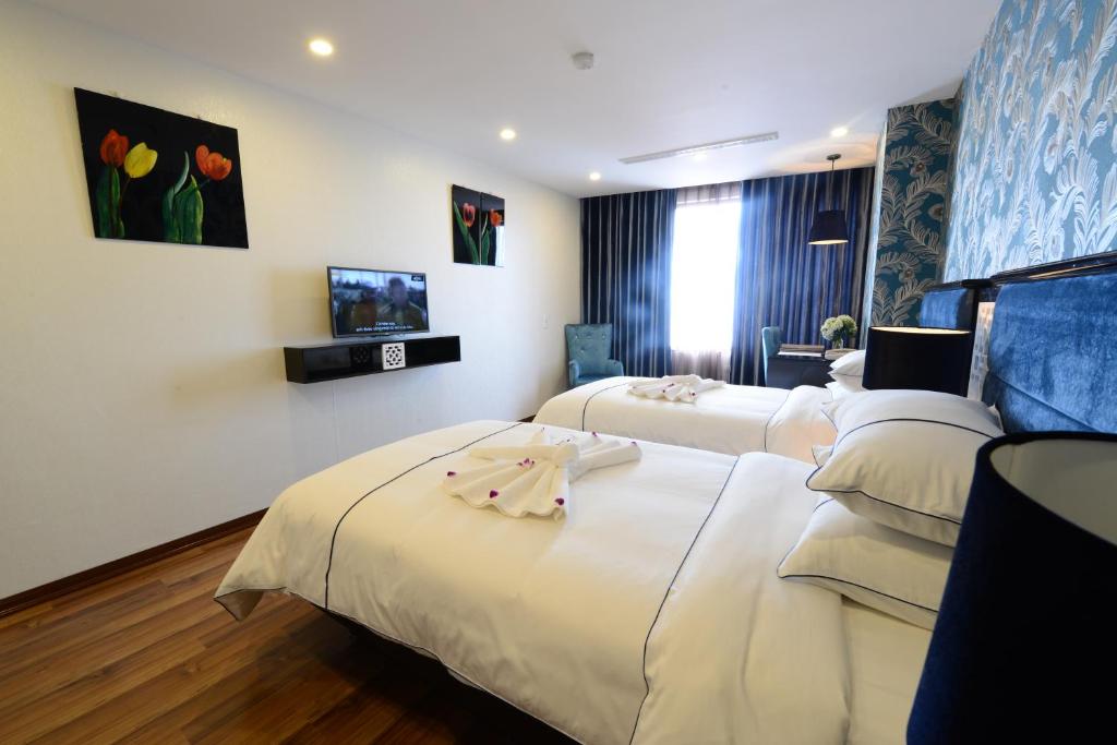Postel nebo postele na pokoji v ubytování Hanoi Emerald Waters Hotel & Spa