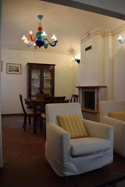 a living room with a chair and a table at Mazzini 16 in Perugia