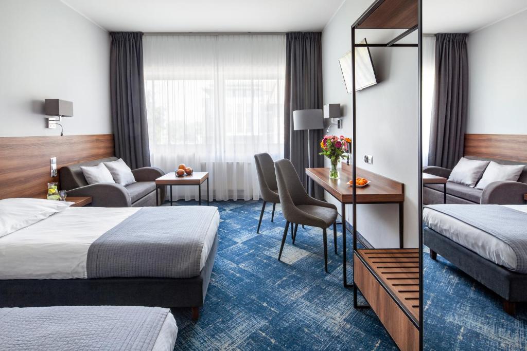 Posteľ alebo postele v izbe v ubytovaní Hotel Oliwski