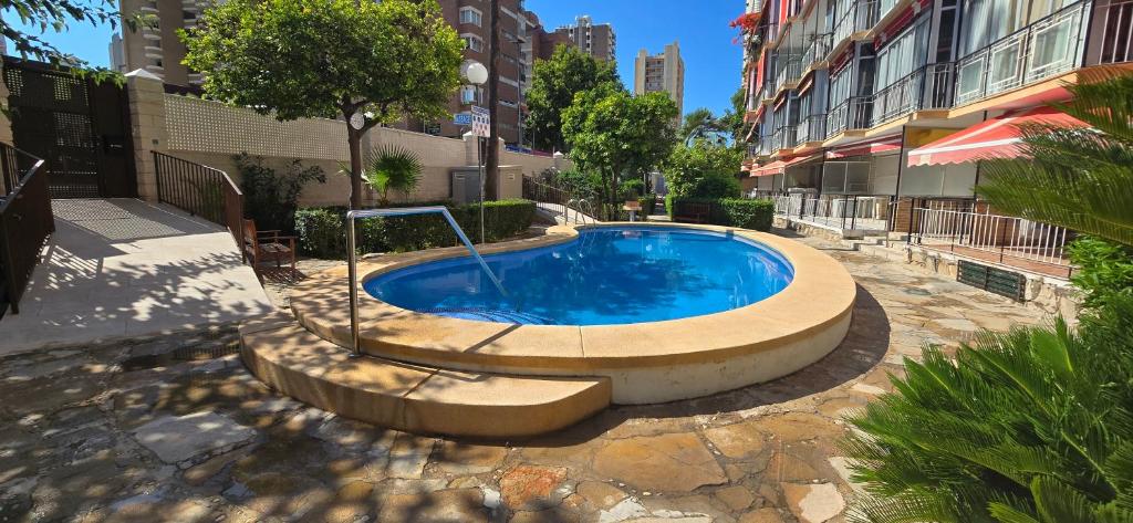 a swimming pool in the middle of a building at ALLONAYA - Fincas Arena in Benidorm