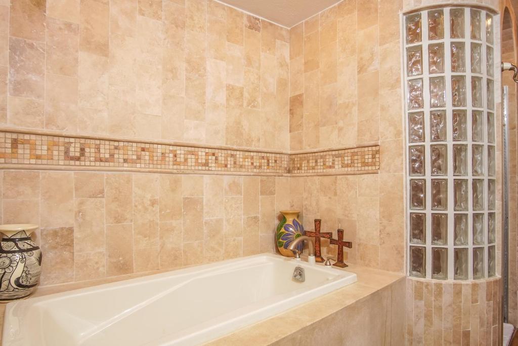 a bathroom with a bath tub and a sink at Bella Sirena in La Choya