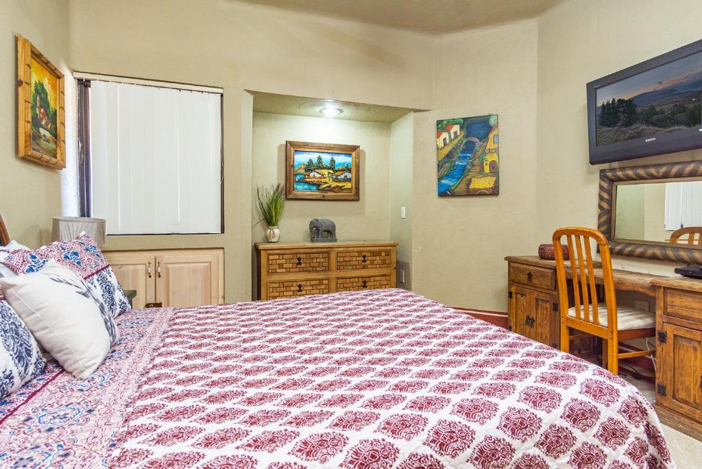 a bedroom with a bed and a desk and a window at Marina Pinacate in Puerto Peñasco