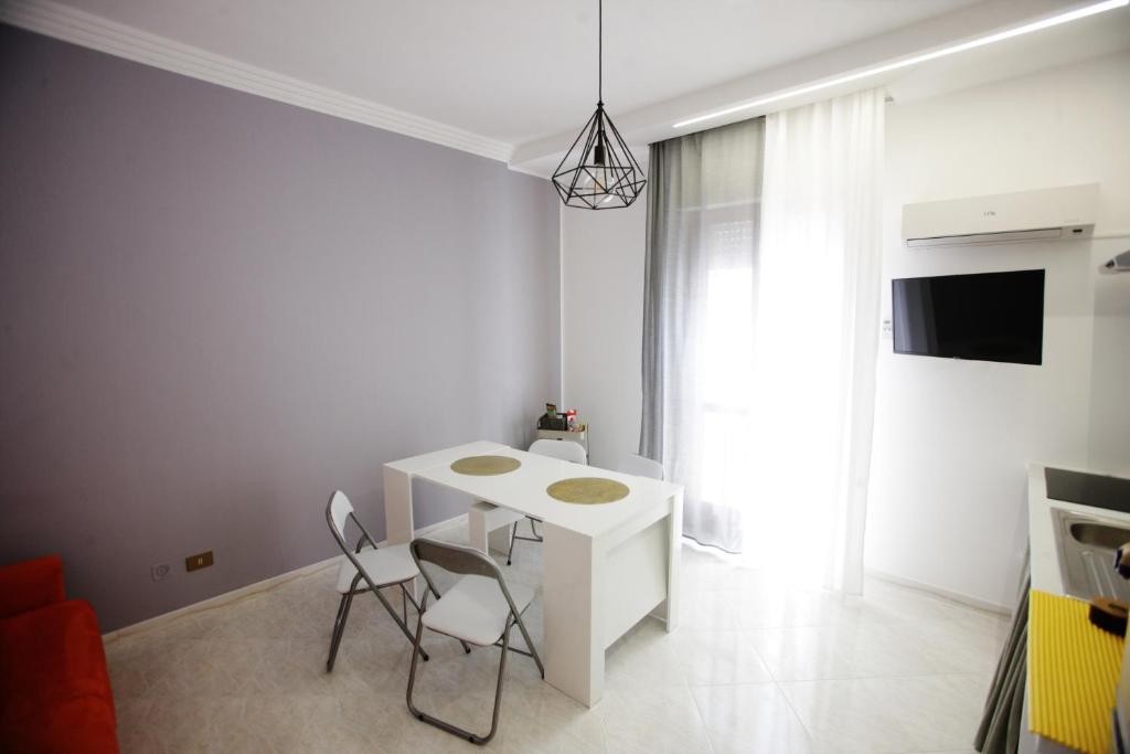 a living room with a white table and chairs at Dream on the blue house 2 in Valderice