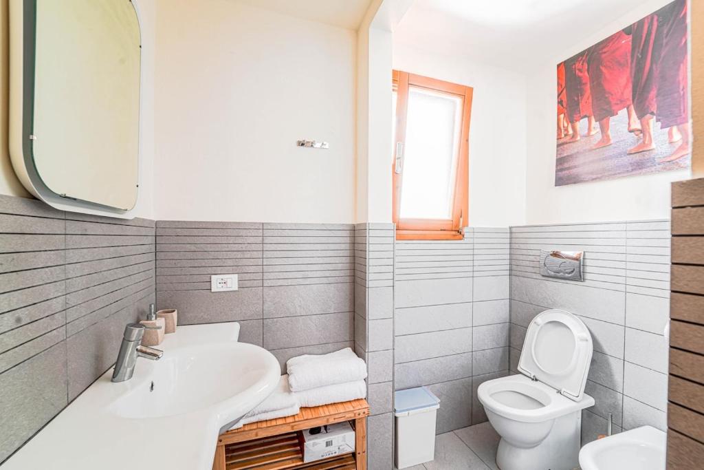 a white bathroom with a sink and a toilet at Diana 1 Apartment the Green Zone of Florence in Florence