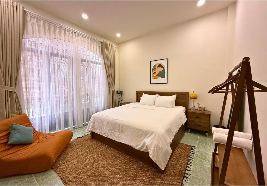 a bedroom with a bed and a large window at City Center Cosy 4BR Townhouse with Garden in D1 in Ho Chi Minh City