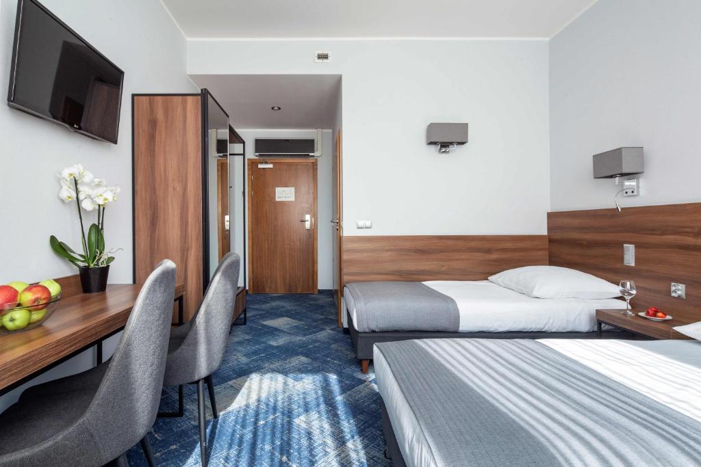 Posteľ alebo postele v izbe v ubytovaní Hotel Oliwski