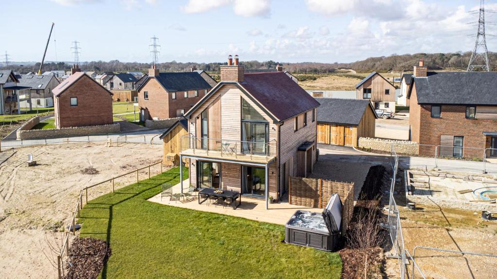 an aerial view of a house with a yard at Sunday Sun BR31 Silverlake Dorset in Warmwell