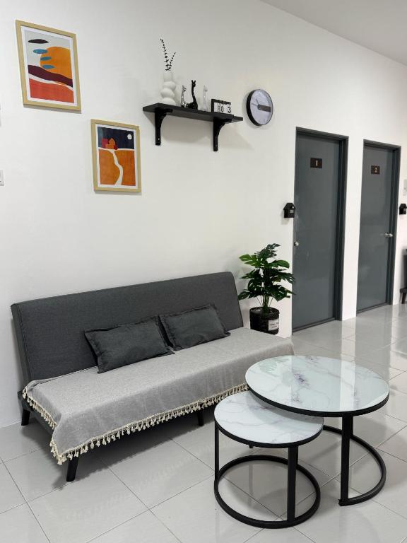 a living room with a couch and a table at Chill Inn Homestay in Jerantut