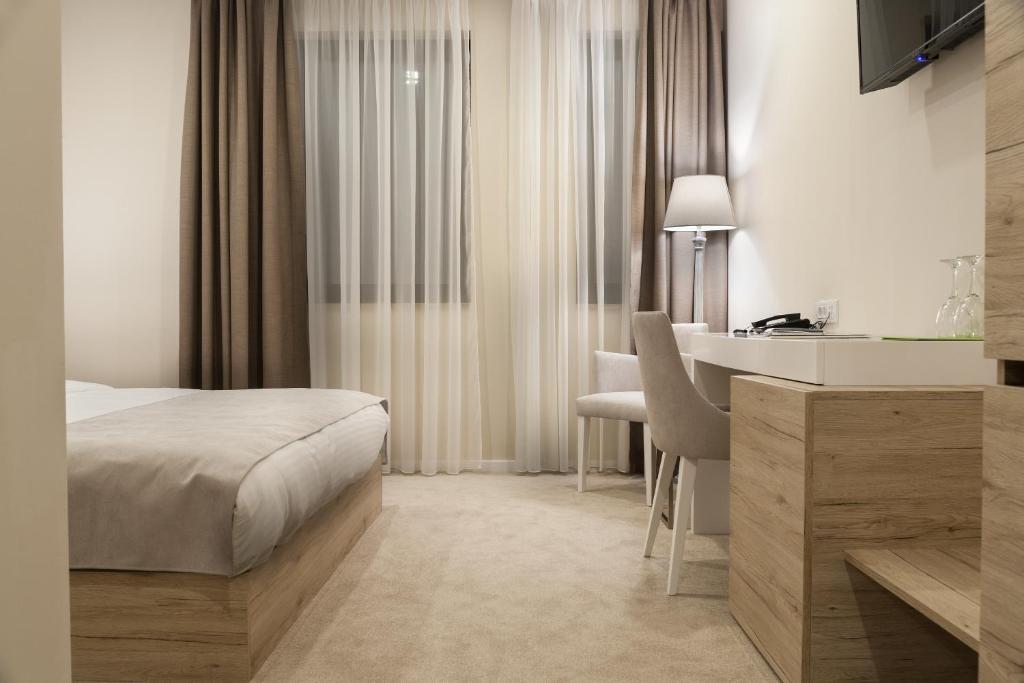 Postel nebo postele na pokoji v ubytování IG Hotel