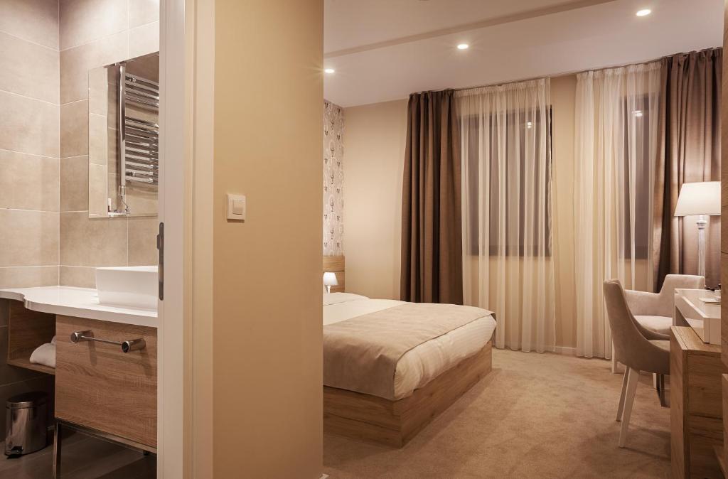 Postel nebo postele na pokoji v ubytování IG Hotel