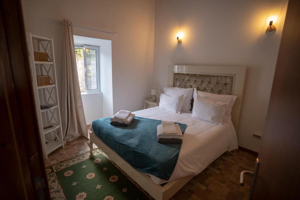 una camera da letto con un letto con due asciugamani sopra di Santana Northeast a Feteira Grande