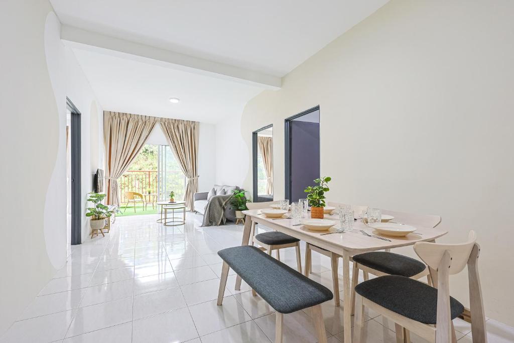 a white dining room with a table and chairs at Cool Climate Comfort Cameron Highlands Holiday Clover Home 4-27 in Brinchang