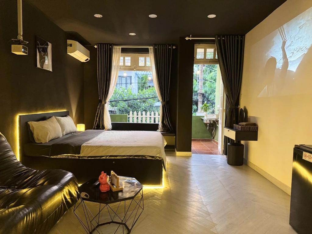 a bedroom with a bed and a couch at Four P Home - Binh Thanh in Ho Chi Minh City