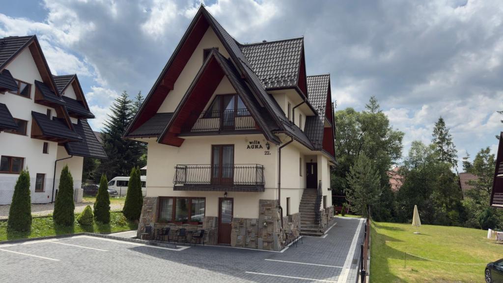 a large white house with a black roof at Willa Agma in Zakopane
