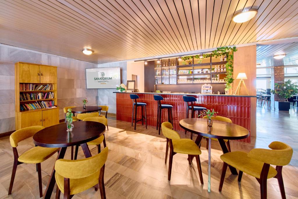 a restaurant with two tables and chairs and a bar at RABKA ZDRÓJ Cegielski - pokoje wyremontowane in Rabka