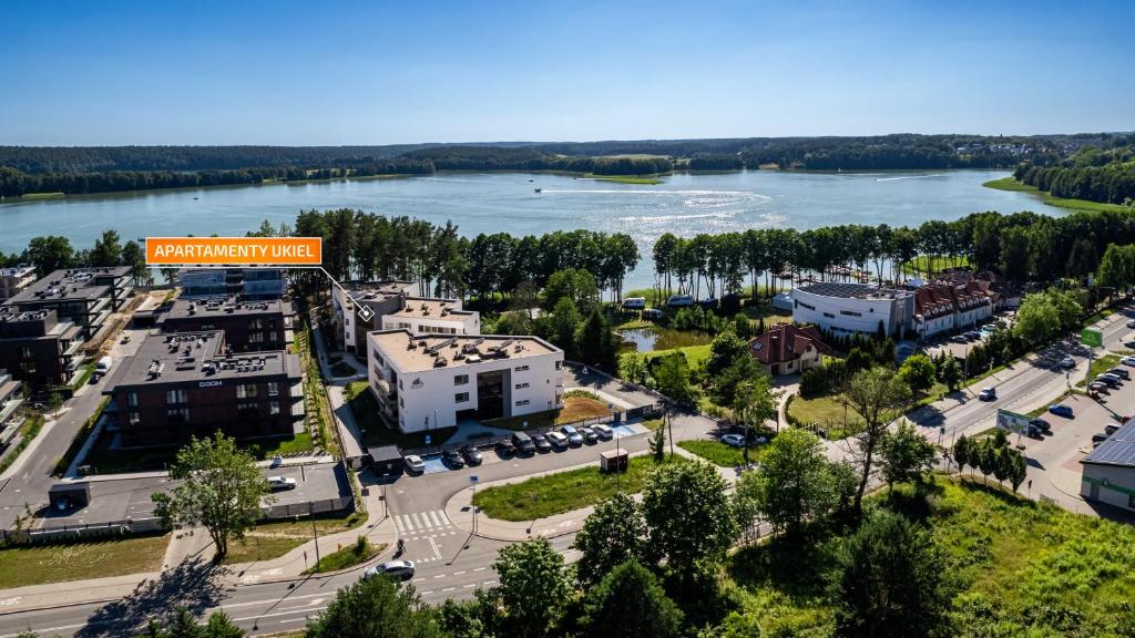 an aerial view of a town with a river at Ukiel, Sun & Snow in Olsztyn