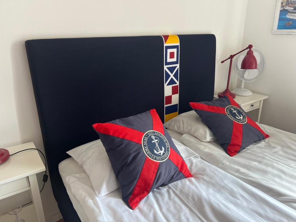 a bed with two pillows on top of it at Smögens Gästhem in Smögen