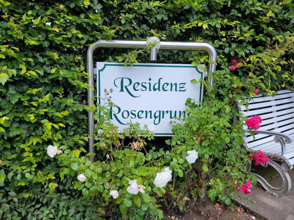 a sign for a restaurant with flowers around it at Fewo Büsum in Büsum