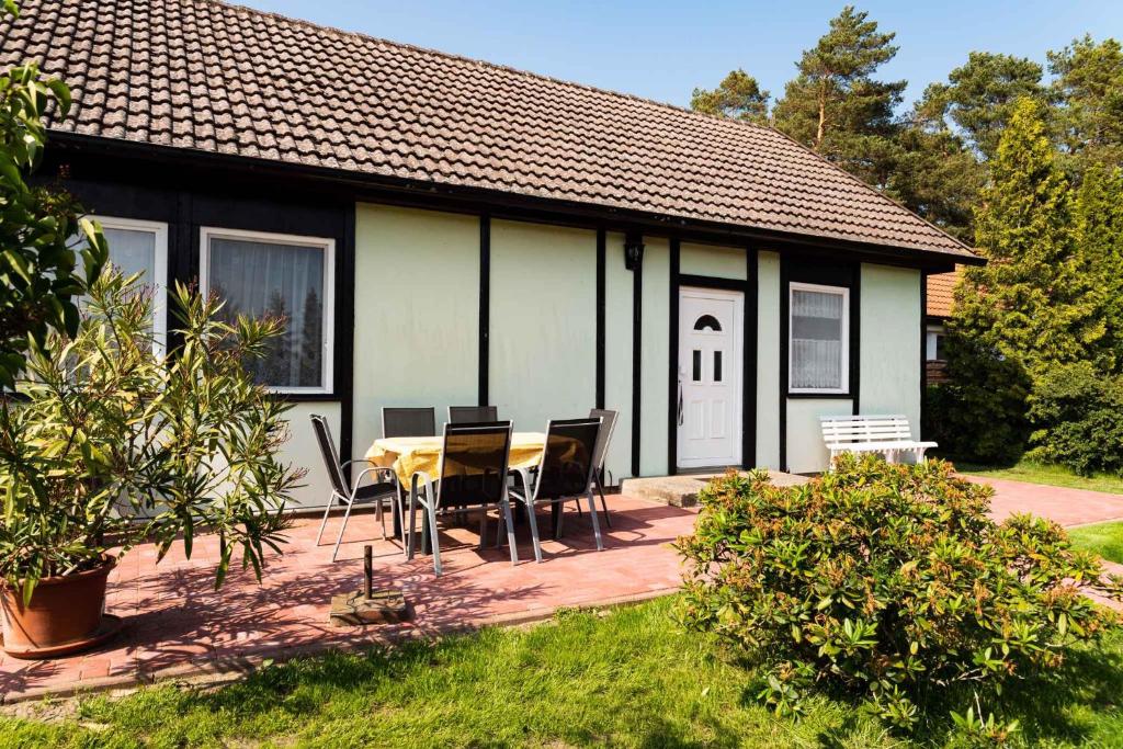 a table and chairs in front of a house at Holiday home Fuhlendorf 2 in Fuhlendorf