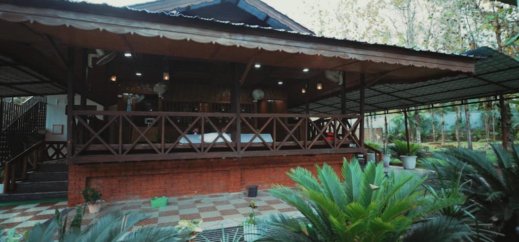 a house with a pavilion in a garden at Sopo Resort in Duimukh