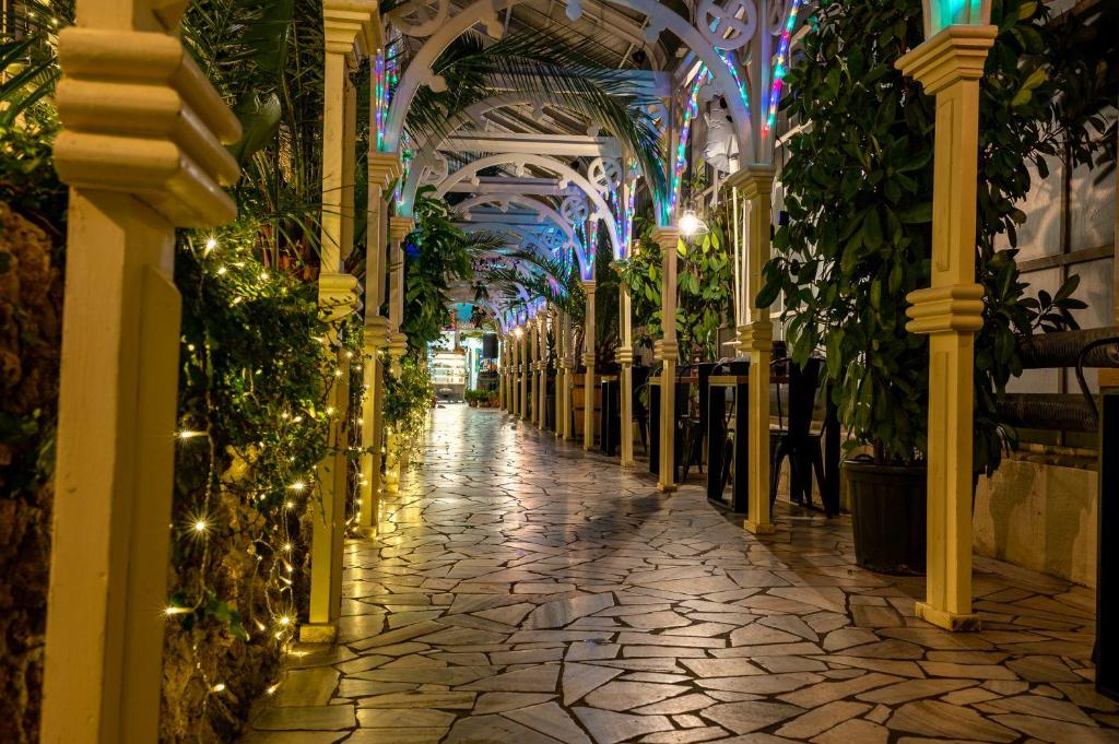 a hallway with plants and lights in a building at Apartament Gold - Góry Sowie - Głuszyca in Głuszyca