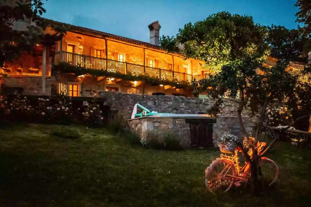 a house with a bike parked in front of it at Luxurious Chateau Asa in Sežana in Sežana