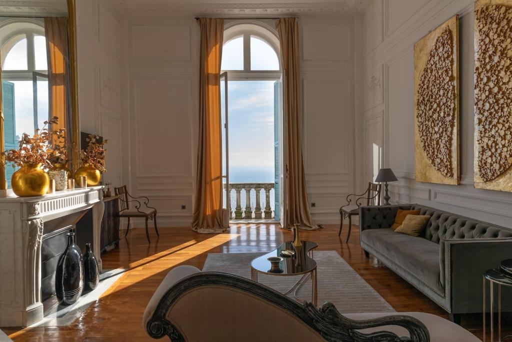 a living room with a couch and a fireplace at Luxury Duplex 2BR Panoramic Sea View Monaco in Beausoleil