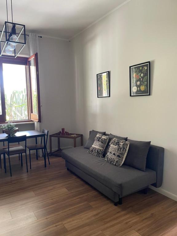 a living room with a couch and a table at Apartments In Villa in Poggiomarino