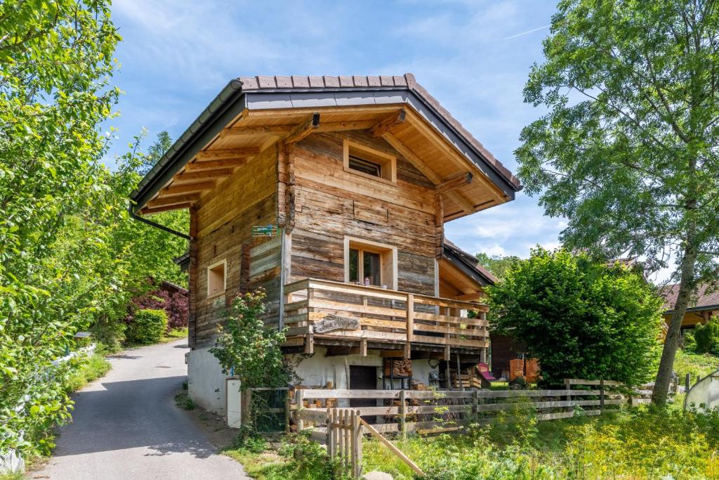 a log house with a gambrel roof at Les Mazots de la Chapelle in Thônes