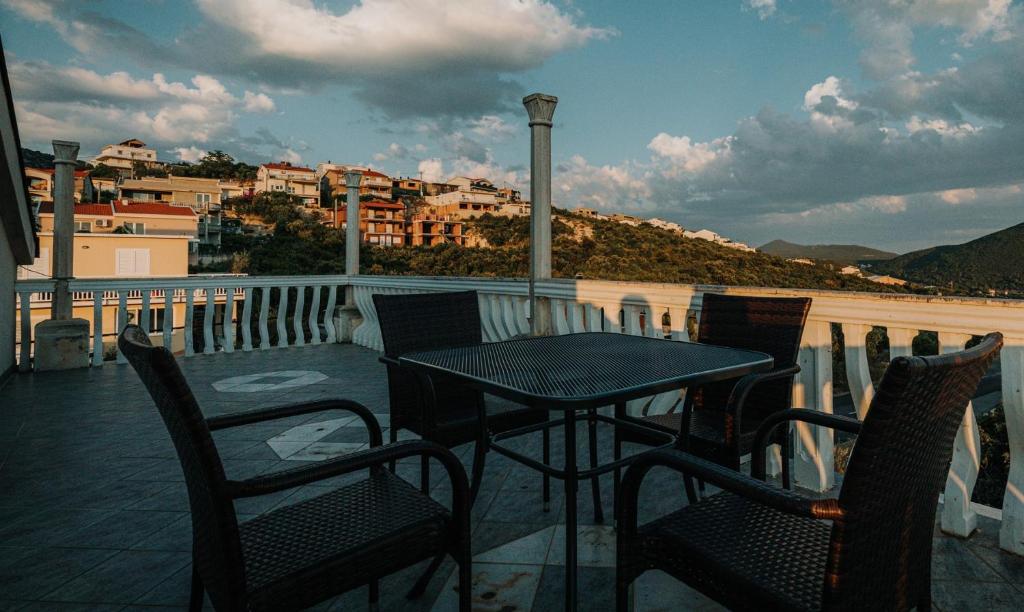 a table and chairs on a balcony with a view at Apartment Sunset Cove in Neum