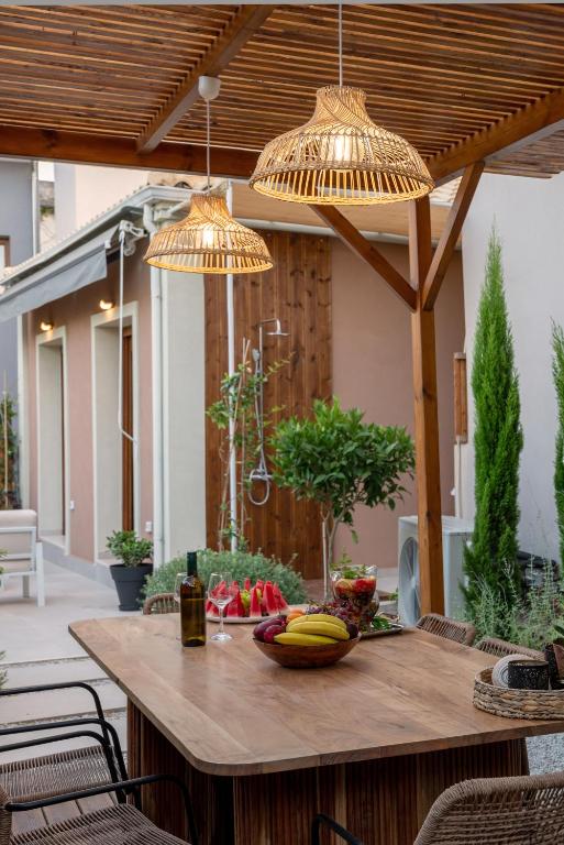 a wooden table with fruit on a patio at Avli in Preveza