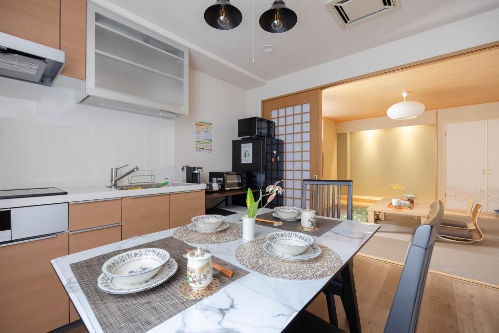 a kitchen and dining room with a table and chairs at Clover House in Tokyo