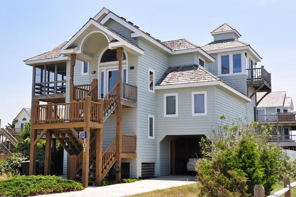 a large house with a porch and a deck at Z Breeze in Nags Head