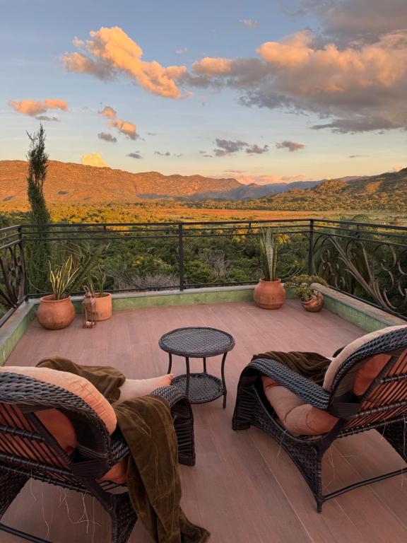 a patio with chairs and a table with a view at Pousada Belvedere da Serra in Serra do Cipo
