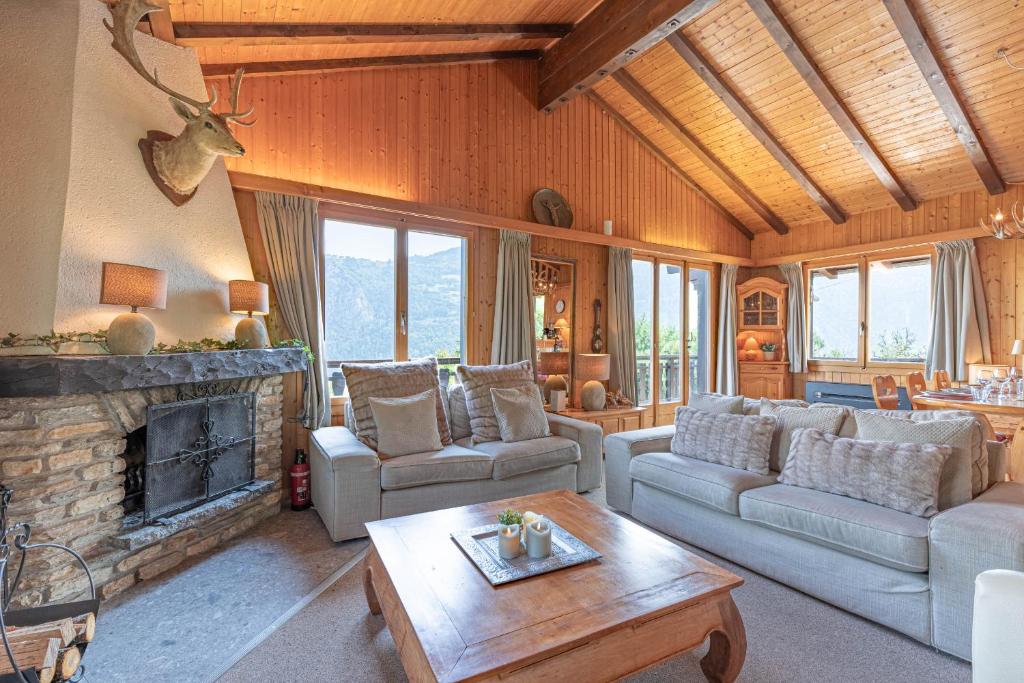 a living room with a couch and a fireplace at Le Petit Renard MOUNTAIN & QUIET 7 pers in Vex