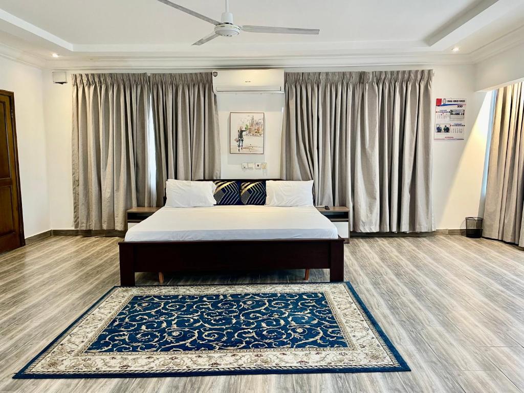 a bedroom with a bed and a blue rug at Beautiful Bedroom Apartment Near Accra Mall Guest Favorite in Accra