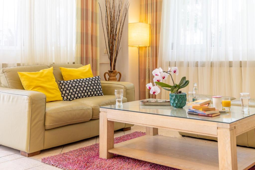 a living room with a couch and a coffee table at Roberto Hotel in Sinaia