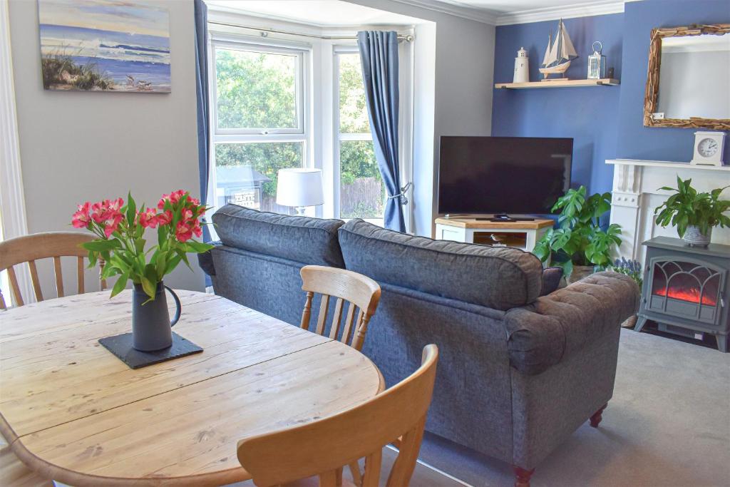 un salon avec un canapé et une table dans l'établissement Turnstone - Suffolk Coastal Escapes, à Pakefield