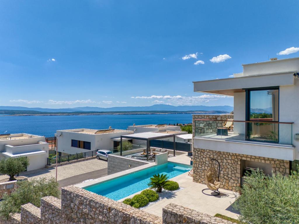 a villa with a swimming pool and a view at Villa Rosciola in Crikvenica