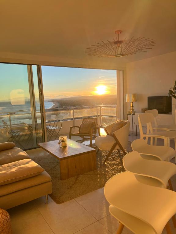 a living room with a view of the sunset at La Grande Tour in Valras-Plage