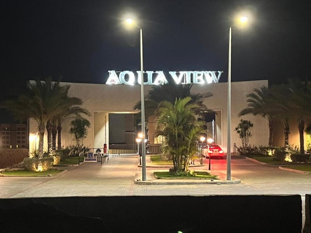 a kola view sign in front of a building at night at Aqua View Studio in Dawwār Abū Maḩrūs