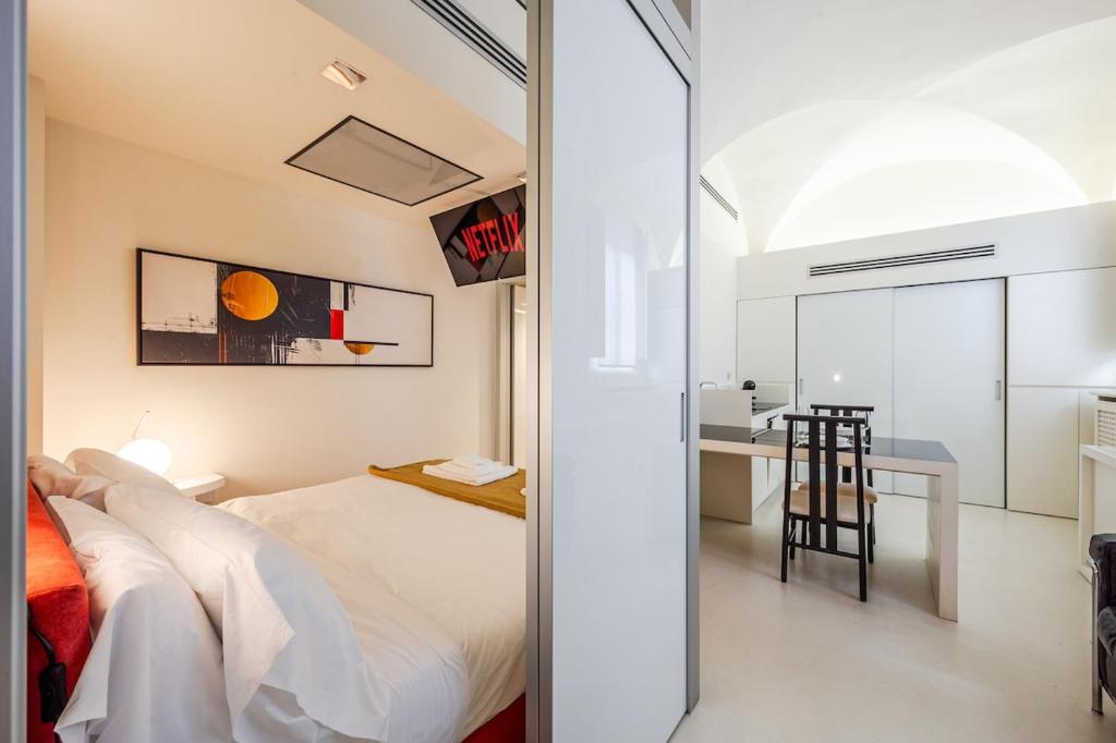 a bedroom with a bed and a desk at Mini-loft just steps from the Duomo of Modena in Modena